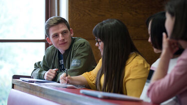 Group of postgraduate students at desk