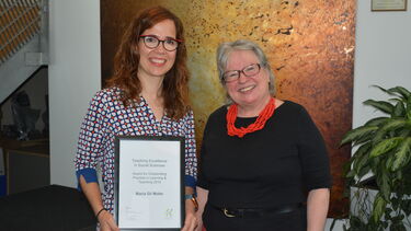 Photo of Maria Gil Molto receiving a Teaching Excellence Award