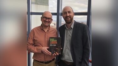 Dr Simon Whawell with his book.