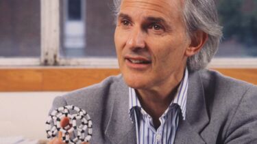 Sir Harry Kroto holding a molecule - image