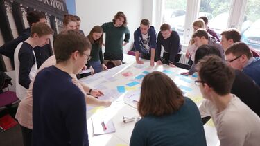 An interactive politics seminar, with students gathered around a table.
