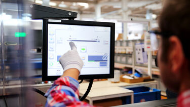 a man points at a screen with data 