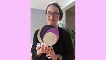 Dr Heidi Christensen holding an award. 