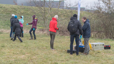 Workshop participants working in a field