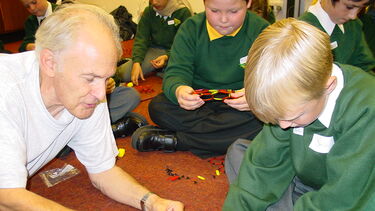 Harry Kroto with a child taking part in a Buckyball workshop.
