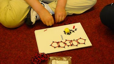 Child taking part in the Buckyball workshop