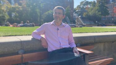 Man outside sat on bench