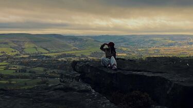 LLM Student QiuYi sitting at Bamford Edge, the Peak District