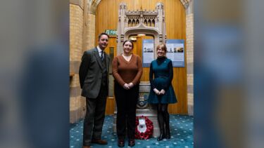 Photo of Miles, Holly and Emily in front of the University war memorial