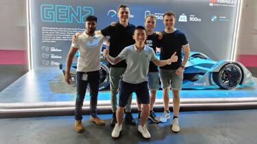 A photograph taken of Kacper with other ZF placement students on a trip to the London Formula E-Prix, standing in front of the Generation 2 electric car which is currently competing in the races