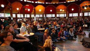 People sat inside the Spiegeltent watching a show during the University of Sheffield's Festival of the Mind