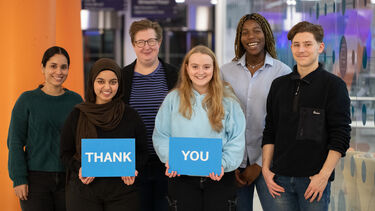 Student callers holding "Thank You" sign