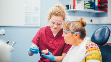 A student and patient talking about oral hygiene 