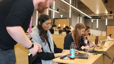 Student talking to Sumo Academy member