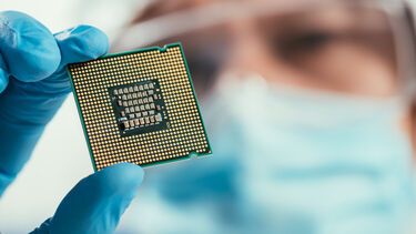 Stock image of researcher holding up chip