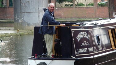 Charles on a boat smiling at the camera