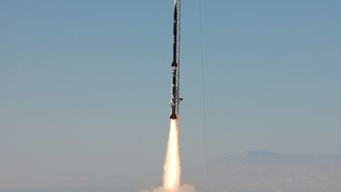 Photo of Karman Alpha accelerating along the launch rail shortly after launch