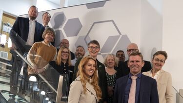 The advisory board stood together on a set of stairs.