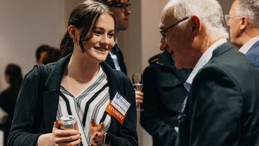 Sheffield alumnus and student engaged in conversation.