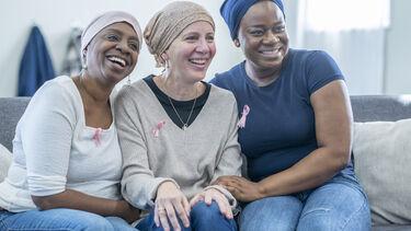 Group of women wearing breast cancer awareness badges
