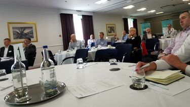 A room of people engaged in a presentation.