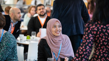 Eva Andriani networking in the cafe.