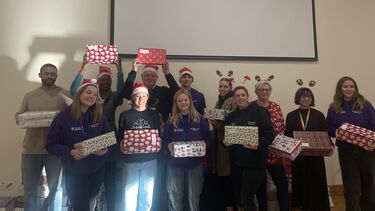 A group photo of the staff and student volunteers at the Christmas Shoebox Appeal wrapping event