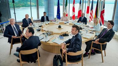 G7 leaders are sat at a table
