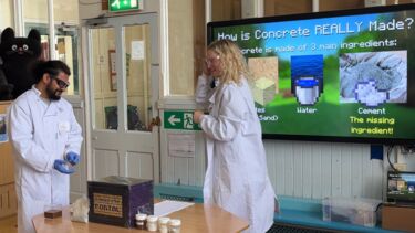 Two researchers leading an outreach session