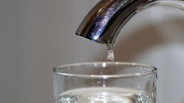 a tap filling up a glass with water