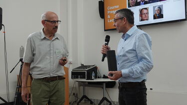 Two academics giving a presentation 