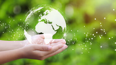 Hands holding a graphic of the earth