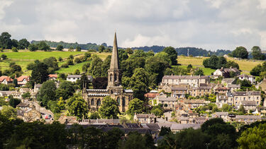 Bakewell village: a church and houses surrounded by trees and green fields 