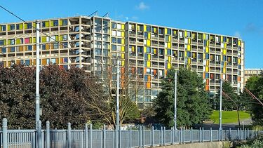 Park hill flats in Sheffield, pictured above a road with a car on it
