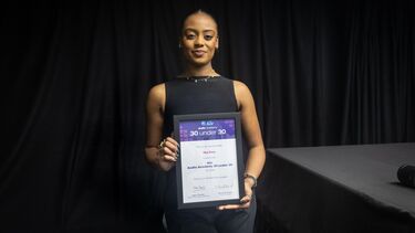 Nia Deo holds an award