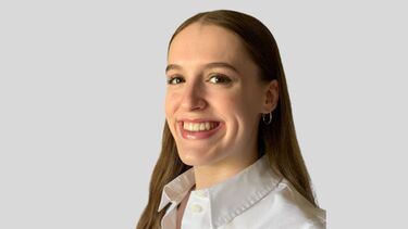A headshot of a smiling young woman in a white shirt