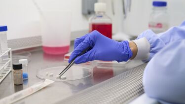 A person looking at a sample in a lab.
