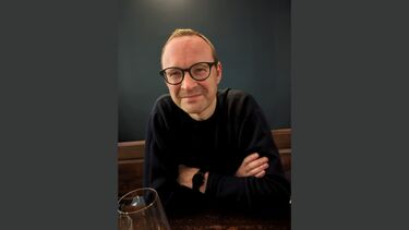 Professor Malcolm Tait against a dark grey background