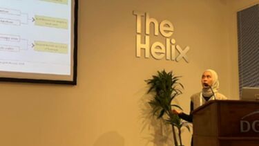 A woman presenting at a conference