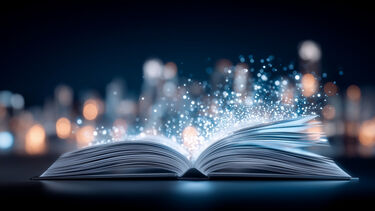 An open book with luminous specks floating away from it