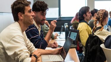 Students with laptops in a lecture theatre