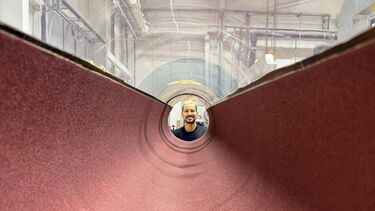 Aaron Kreji looking down the length of a pipe