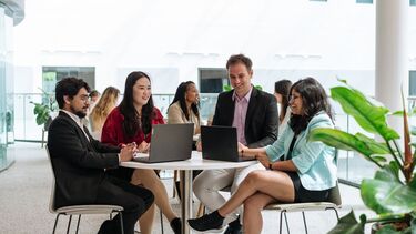 Group of students sat around a table
