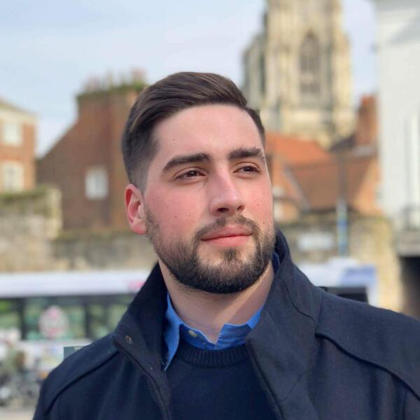 Profile picture of A man wearing a dark blue coat