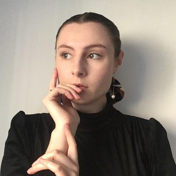 Profile picture of Ann Thompson holds her face in a pose