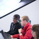 MSc Economics and Public Policy postgraduate Mwanda Phiri at computer with colleague
