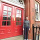 Joanna Jones outside the red doors of ACSE's Amy Johnson Building