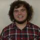 A profile picture of Russell Grim. He has on a tartan shirt.
