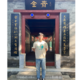 Photo of a Maths student standing by a decorative doorway
