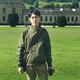 Student stood outside a country house